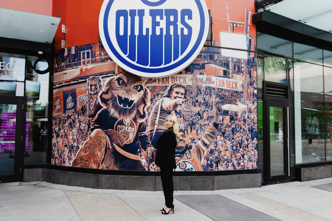 Makayla Noble in a black suit at the Edmonton Oilers ICE District.